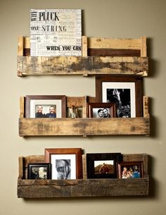 three wooden shelves with pictures on them in a living room or dining room, one is made out of pallet wood and the other has multiple frames