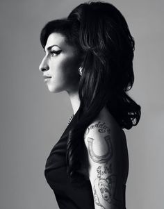a woman with tattoos on her arm and shoulder