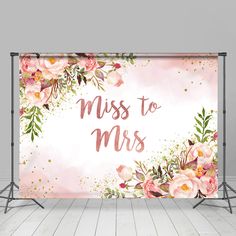 a pink floral backdrop with the words miss to mrs on it