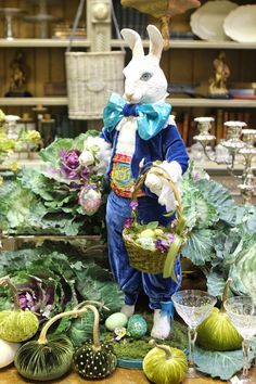 a table topped with lots of vegetables and an easter bunny statue