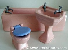 two toy toilets and a sink on a table