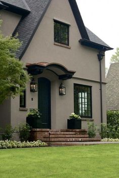 a gray house with black trim and windows