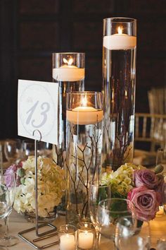 the centerpieces are filled with candles and flowers