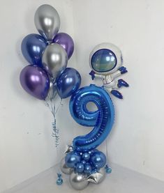 an astronaut balloon with the number nine on it and balloons in the shape of numbers