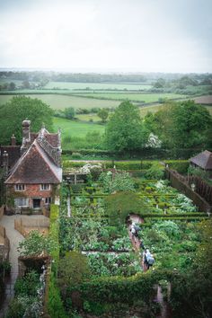 an aerial view of a garden in the middle of a country house with lots of greenery
