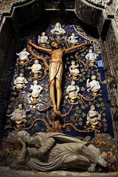 the crucifix is surrounded by statues
