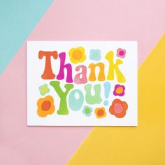 a thank you card with colorful flowers and the words thank you written in bright colors