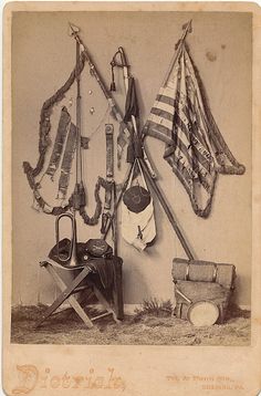 an old time photo with various items hanging on the wall