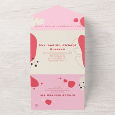 a pink and white wedding card with hearts on the front, in two different colors