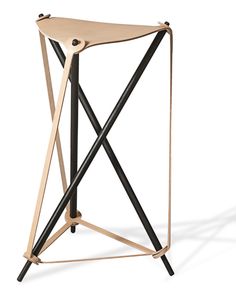 a wooden table with black legs and a metal frame on it's side, against a white background