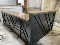 a black and wood bar in the process of being installed
