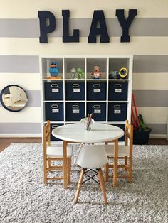 a play room with striped walls and white carpet