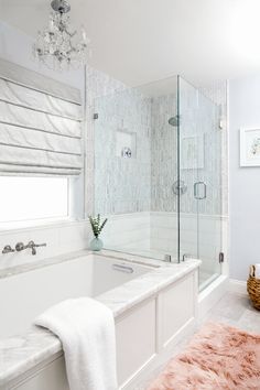 a bathroom with a tub, shower and rug