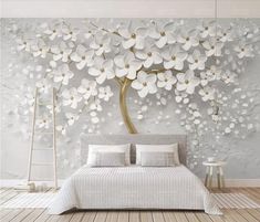 a bedroom with white flowers on the wall and a large bed in front of it