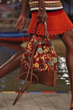 a close up of a person carrying a purse