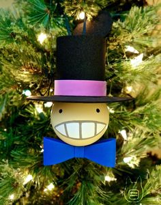 a christmas ornament with a hat and bow tie on it's head