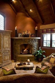 a living room filled with furniture and a fire place in the middle of a room