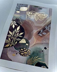 an abstract painting with gold leaves and butterflies on it's back side is shown