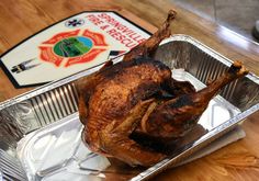 a roasting pan with a whole chicken in it