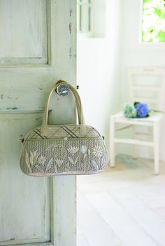 a purse hanging from the side of a door