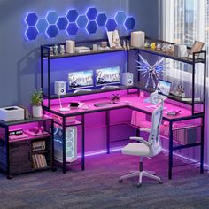 a computer desk with purple lighting in an office