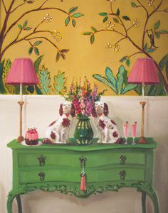 a painting of two dogs sitting on top of a green dresser with pink lamps in front of it