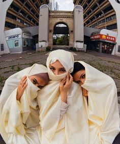 two women dressed in white covering their heads