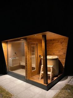 an outdoor sauna is lit up at night