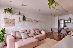 a living room filled with furniture and a white brick wall