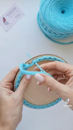 someone is working on something with yarn and scissors