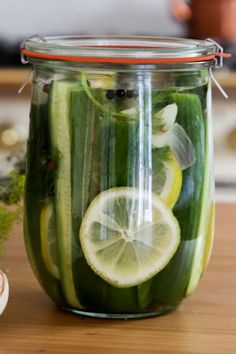 a jar filled with cucumbers and lemon slices
