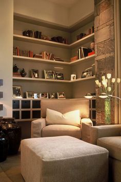a living room filled with furniture and bookshelves