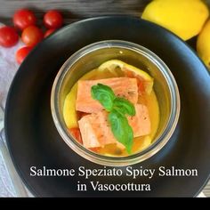 salmon in sauce with tomatoes and lemons on the side