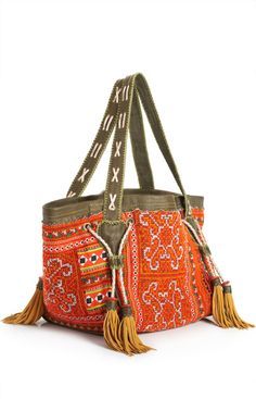 an orange purse with tassels on it