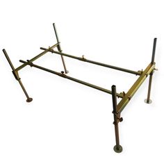 a metal bed frame with four legs and two bars on each side, against a white background