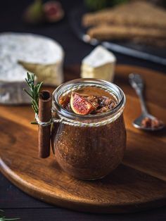 a glass jar filled with food sitting on top of a wooden cutting board