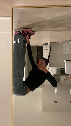 a man is hanging upside down on the ceiling with his skateboard in hand and another person taking a photo behind him