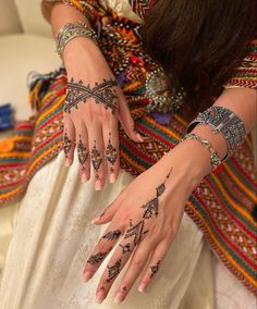 a woman with henna tattoos on her hands