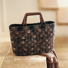 a brown woven basket sitting on top of a counter