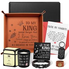 an open box with some cards and other items in it, including a ring on the inside