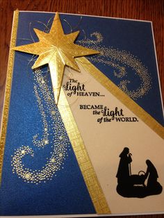 a christmas card with a star and nativity scene