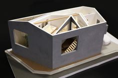 a model of a house is shown on a table