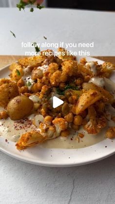 a white plate topped with fried food on top of a table
