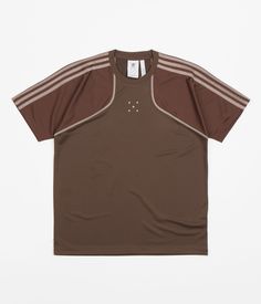 Description Adidas x Pop Trading Company Tech T-Shirt Adidas x Pop Trading Company Tech T-Shirt in Deepest Earth, Auburn and Clay Brown. Tailored to a regular fitting from 100% recycled polyester, this adidas t-shirt has been co-designed in partnership with Pop Trading Company. Styled with a hydrophilic coating and ergonomically cut sleeves, this brown adidas tech t-shirt also features a flexible rib knit collar, a straight cut hem and triple stripe sleeve and shoulder branding. Inspired by vint Shirts, Tech T Shirts, Adidas Tech, Adidas, Sportswear, Mens Outfits, Shirt Designs, T Shirt