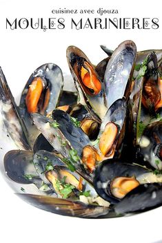 a white bowl filled with mussels covered in sauce and garnished with parsley