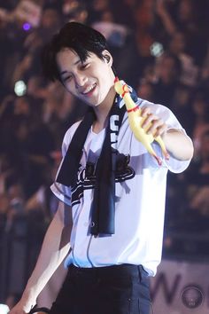 a young man holding a banana in his right hand