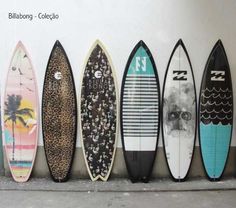 several surfboards lined up against a wall