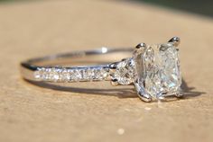 a diamond ring sitting on top of a wooden table