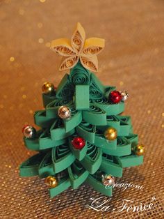 a small christmas tree made out of green paper