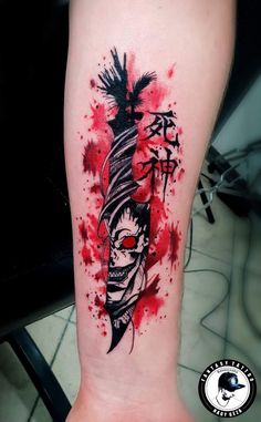 a tattoo on the leg of a person with red paint splattered over it